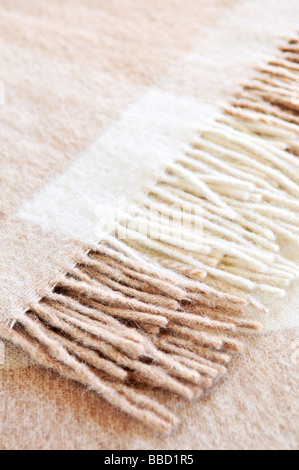 Soft and warm folded alpaca wool blanket with fringe Stock Photo