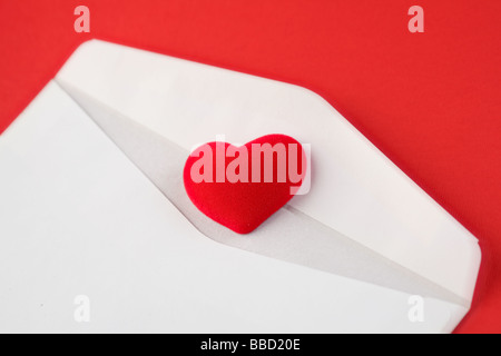 A red heart on a white envelope Stock Photo