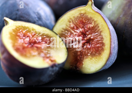 Closeup view of figs sliced in half on a blue plate Stock Photo