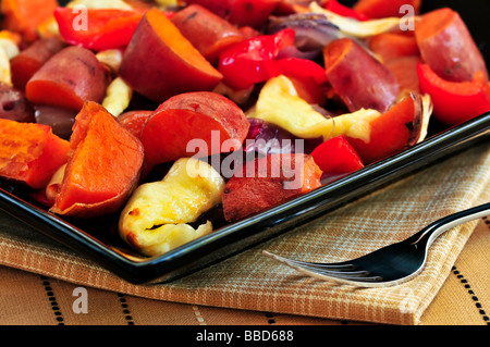 Vegetarian dish of roasted yams with cheese and peppers Stock Photo