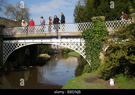 People stood on bridge in the Pavilion gardens in the Spa town of Buxton in the Peak District Derbyshire England UK Stock Photo