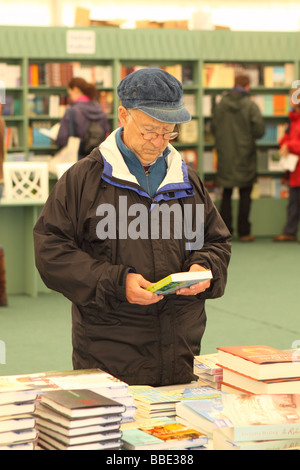 Hay Festival an elderly man looking at books at the festival book store May 2009 Stock Photo