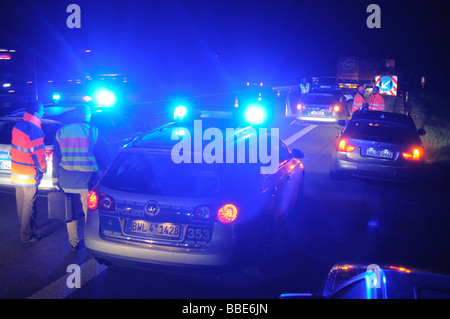 Police patrol car with flashing lights securing an accident scene on the highway A 8 en route to Munich between the airport and Stock Photo