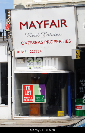 An empty overseas real estate shop with a large To Let sign in its front window Margate Kent UK Stock Photo