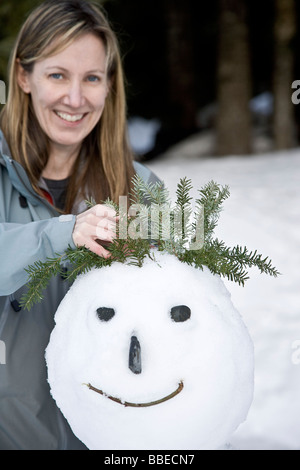 Woman Making Snowman Stock Photo