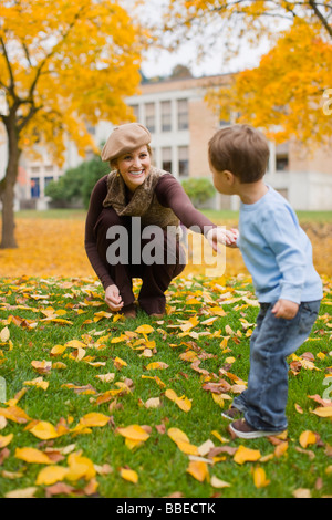 Mother and Son Playing in the Park in Autumn, Portland, Oregon, USA Stock Photo