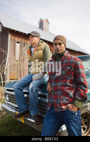 Two Young Men by an Old Pickup Truck on a Farm in Hillsboro, Oregon, USA Stock Photo