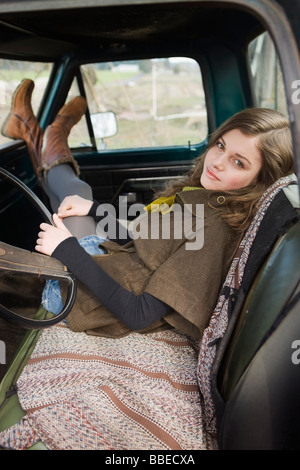 Teenage Girl Sitting in the Cab of an Old Pickup Truck on a Farm in Hillsboro, Oregon, USA Stock Photo