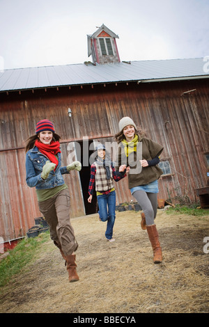 Three Teenage Girls Running on a Farm in Hillsboro, Oregon, USA Stock Photo