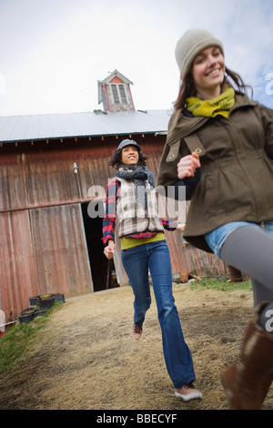 Two Teenage Girls Running on a Farm in Hillsboro, Oregon, USA Stock Photo