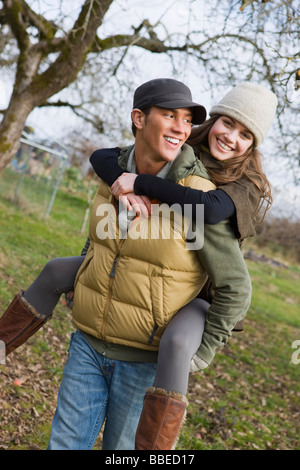 Teenage Boy Giving Girlfriend a Piggyback Ride, Hillsboro, Oregon, USA Stock Photo