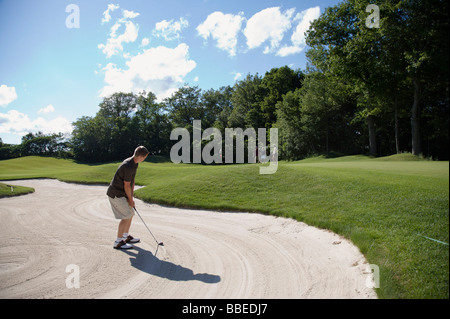 Man in Sand Trap, Burlington, Ontario, Canada Stock Photo