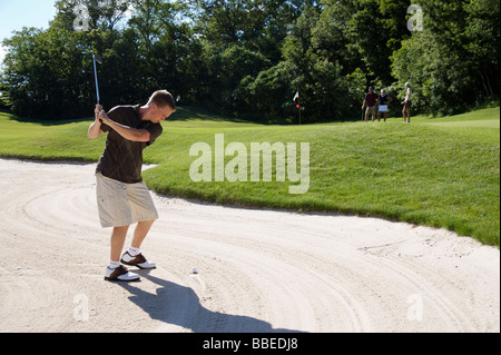 Man in Sand Trap, Burlington, Ontario, Canada Stock Photo