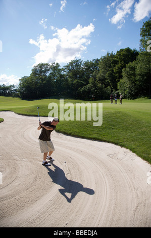 Man in Sand Trap, Burlington, Ontario, Canada Stock Photo