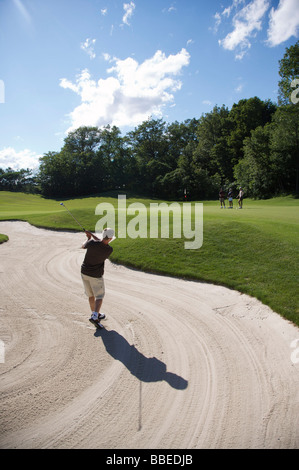 Man in Sand Trap, Burlington, Ontario, Canada Stock Photo