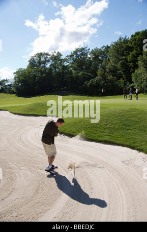 Man in Sand Trap, Burlington, Ontario, Canada Stock Photo