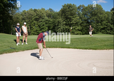 Man in Sand Trap, Burlington, Ontario, Canada Stock Photo