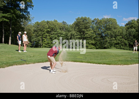 Man in Sand Trap, Burlington, Ontario, Canada Stock Photo