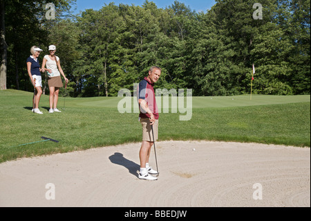 Man in Sand Trap, Burlington, Ontario, Canada Stock Photo