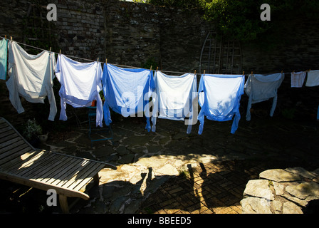 Mens shirts on a traditional washing line in sunlight Stock Photo