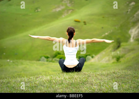 woman practicing yoga. Cleeve Hill Stock Photo