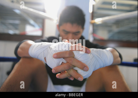Boxer wearing bandage in his both hands Stock Photo
