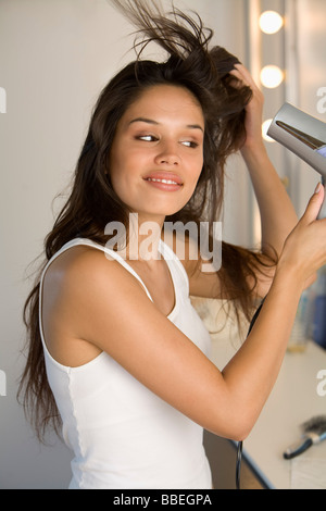 Woman Blow Drying Her Hair Stock Photo