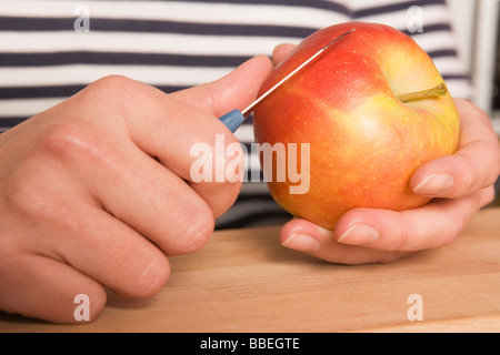 Hands Slicing Apple Stock Photo