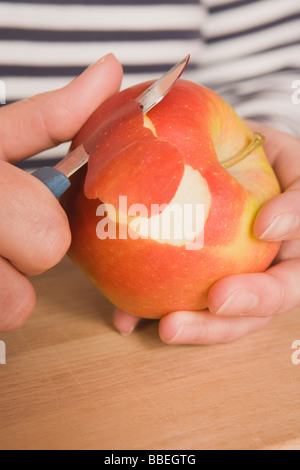 Hands Peeling Apple Stock Photo