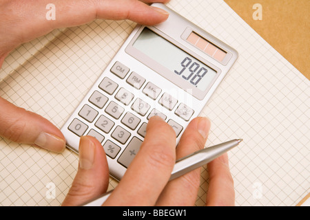 Hands Using Calculator Stock Photo