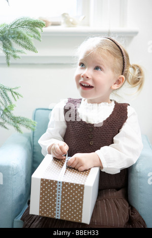 Little Girl Opening Present Stock Photo