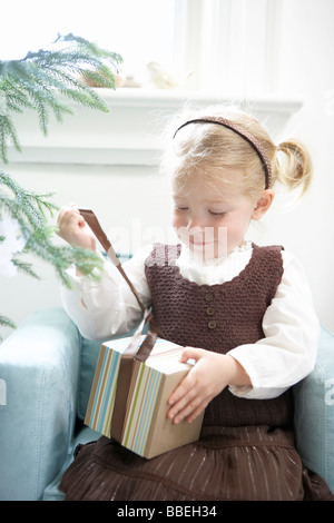 Little Girl Opening Present Stock Photo