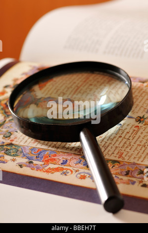 Magnifying Glass on Page of Book Stock Photo