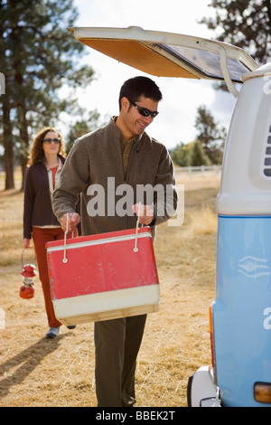 Couple Loading Van For a Camping Trip, Bend, Oregon, USA Stock Photo