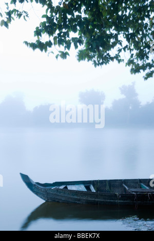 Canoe in Morning Mist at Sras Srang, Angkor, Cambodia Stock Photo