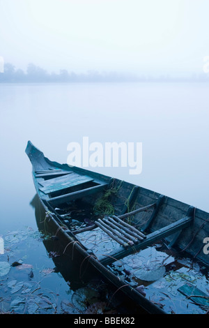 Canoe in Morning Mist at Sras Srang, Angkor, Cambodia Stock Photo