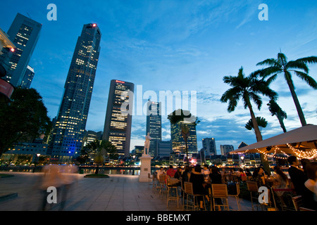 Skyline of Singapore  Raffles Statue street cafe South East Asia twilight Singapur Stock Photo