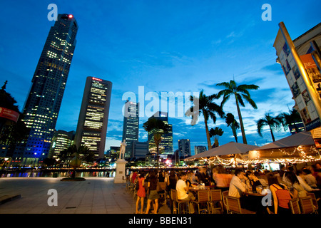 Skyline of Singapores Raffles Statue street cafe South East Asia twilight Stock Photo