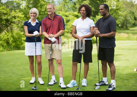 Portrait of Couples Standing and Leaning on Golf Clubs Stock Photo