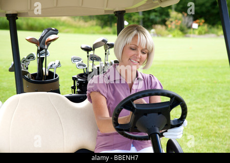 Woman Sitting in Golf Cart Stock Photo