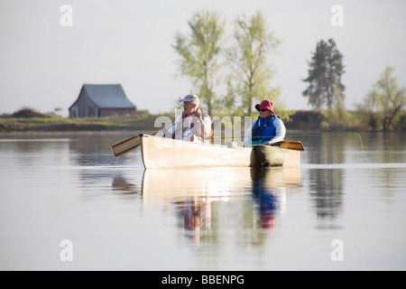 Elderly couple fly fishing in canoe, Amber Lake, Washington Stock Photo
