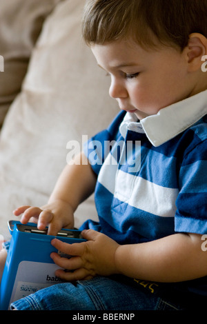 Two year old boy playing with flash cards Stock Photo