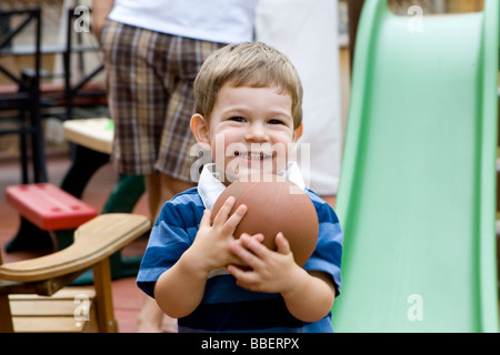 Two year old boy holding a ball, Milton, Ontario Stock Photo