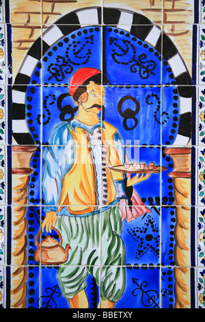 A ceramic wall decoration with a Tunisian man in traditional attire serving tea at Cafe Charbi Khemais in Sousse, Tunisia Stock Photo