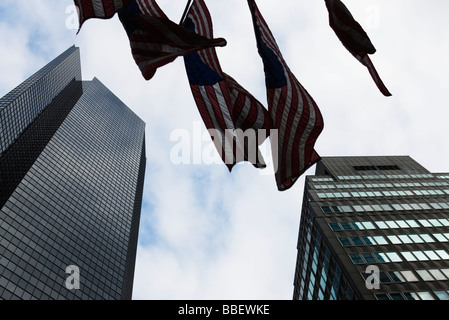 Skyscrapers, flags waiving in breeze, viewed from below Stock Photo