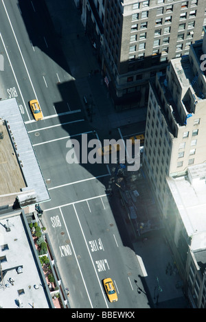 Aerial view of taxis on street lined with high rise buildings Stock Photo