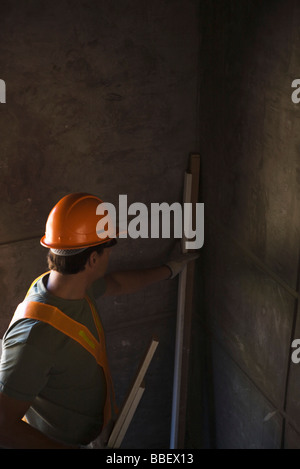 Construction worker placing wood in corner Stock Photo