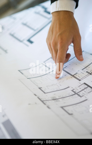 Hand pointing at area on blueprint, close-up Stock Photo