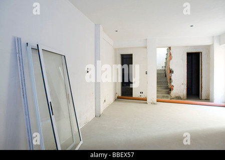 Interior of apartment under renovation, windows leaning against wall Stock Photo