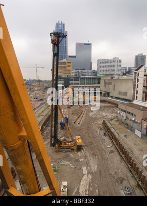 Big construction site in the city centre of Rotterdam with very large pole driving equipment the Netherlands Stock Photo